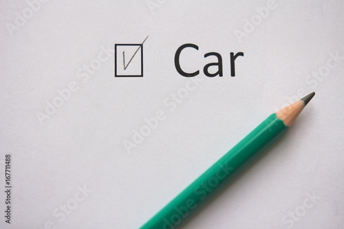 Buy car. The word CAR is written on white paper with a tick and a gray pencil.