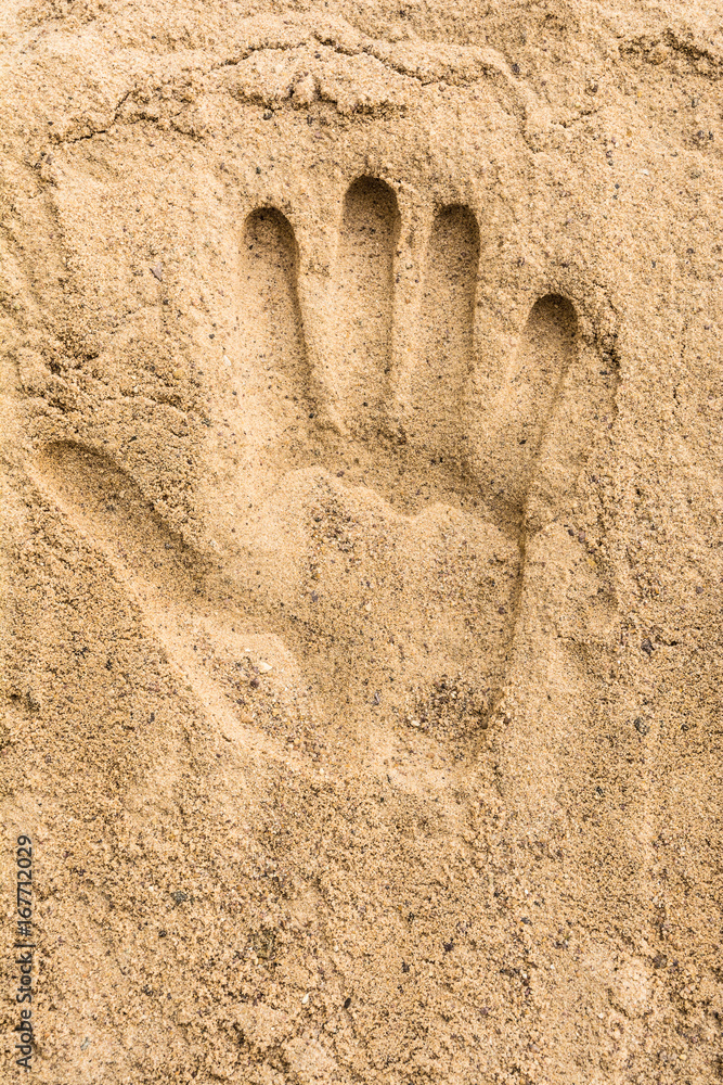 Hand print on the sand beach texture background Hand print on the sand beach texture background