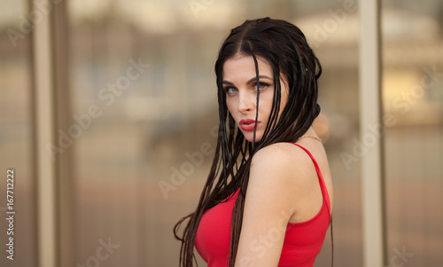 Young brunette woman outdoors portrait. Soft sunny colors.Close portrait.