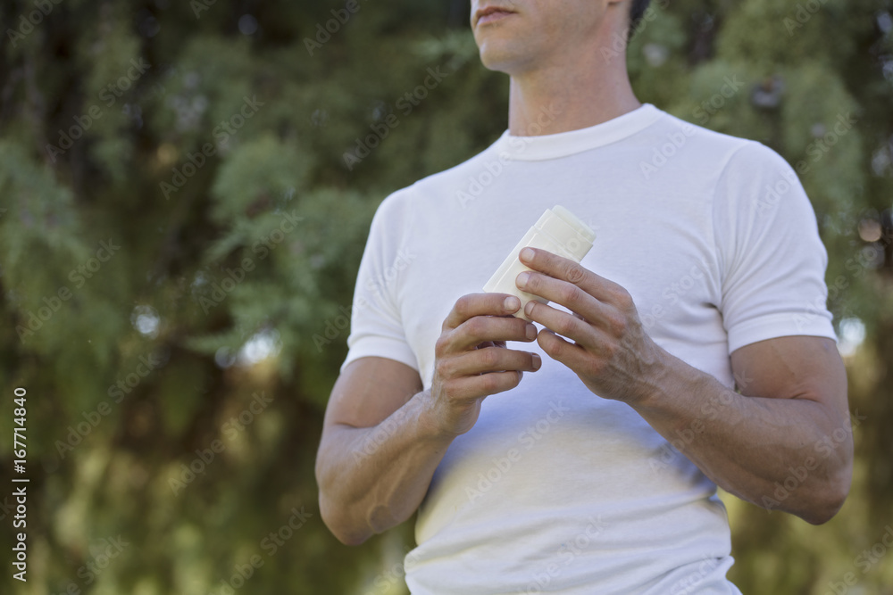 Mosquito repellent. Male using insect repellent spray from bottle in forest. Mosquito repellent. Male using insect repellent spray from bottle in forest.