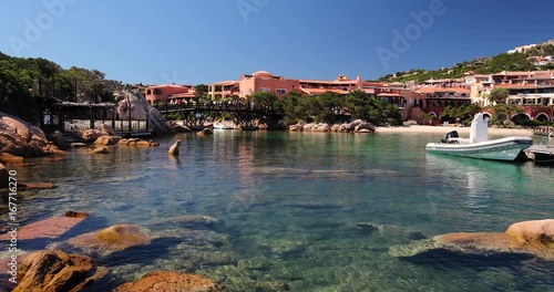 Coastline promenade with pine trees and yachts at Porto Cervo town. Porto Cervo is capital of Sardinia, Italy.