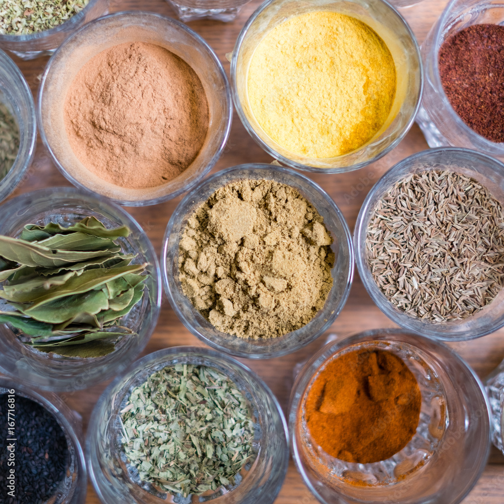 variation of colorful spices - dry spices on table variation of colorful spices - dry spices on table