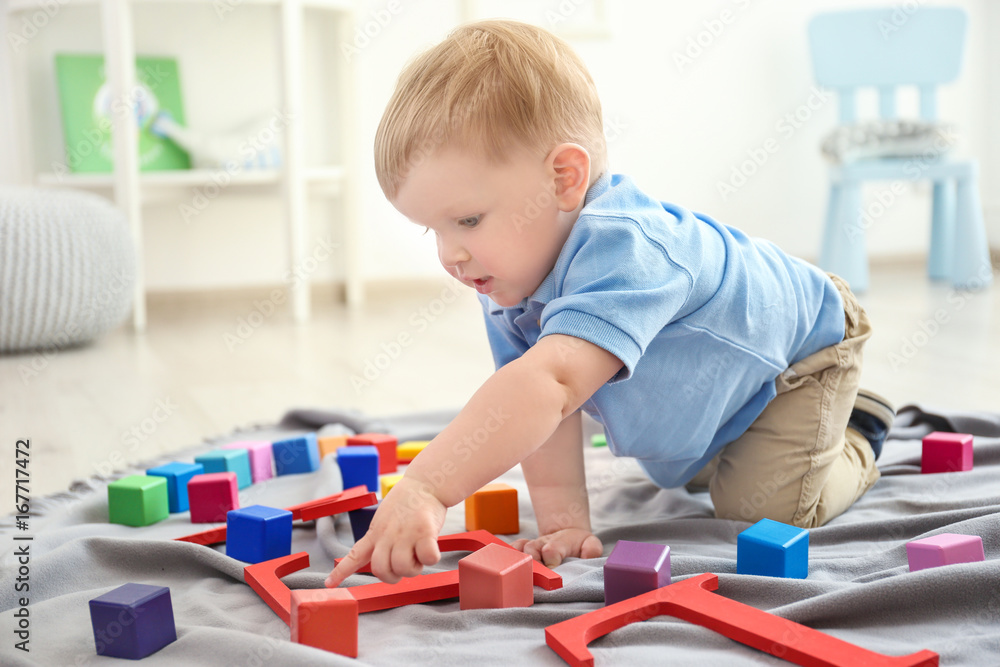 Cute little boy playing on floor at home Cute little boy playing on floor at home