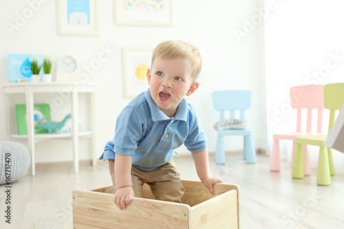 Cute little boy standing in...