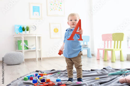 Cute little boy holding let...