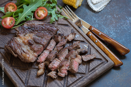 Grilled Steak on cutting board with green salad