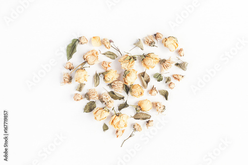 Autumn composition. Heart symbol made of dried autumn flowers and leaves. Top view, flat lay