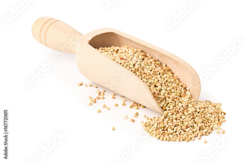 Raw, natural, uncooked buckwheat seed kernels in wooden scoop