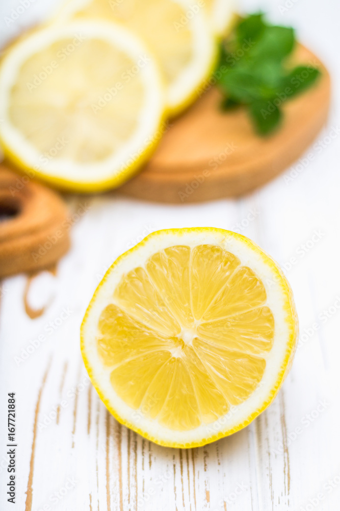 Lemons on a board on a white wooden background. Lemons on a board on a white wooden background.