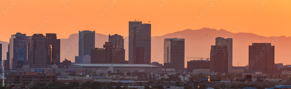 downtown Phoenix, Arizona skyline with famous camelback mountain at sunset