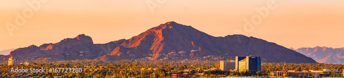 downtown Phoenix, Arizona skyline with famous camelback mountain at sunset