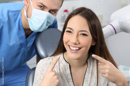Satisfied dentist patient showing her perfect smile
