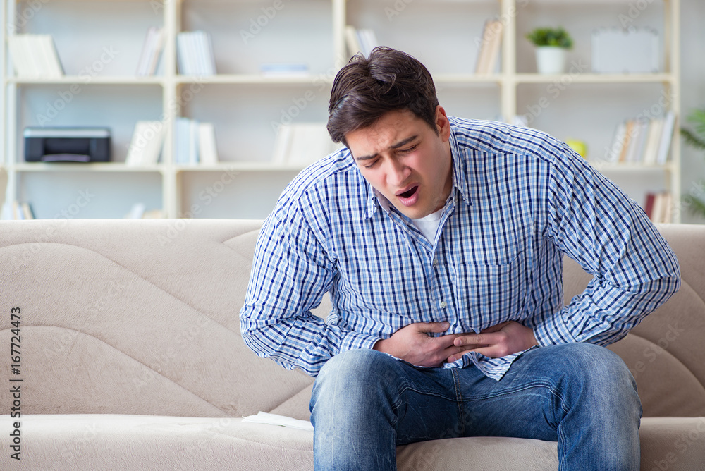 Man suffering from pain at home Man suffering from pain at home