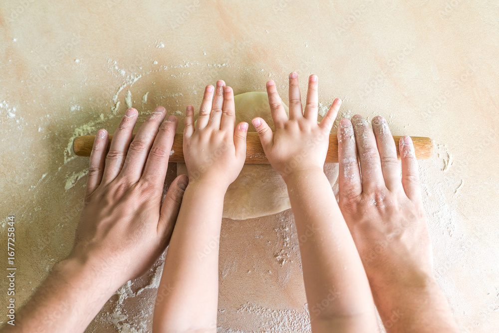 Children and dad hands rolled dough Children and dad hands rolled dough