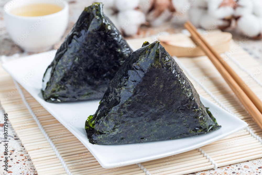 Korean triangle kimbap Samgak with nori, rice and tuna fish, similar to