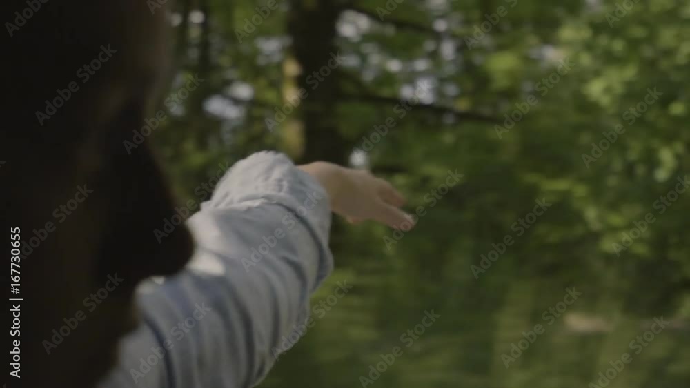 Closeup Of Young Woman, She Puts Her Arm Out Car Window, Drives Through Forest, Slow Motion Closeup Of Young Woman, She Puts Her Arm Out Car Window, Drives Through Forest, Slow Motion