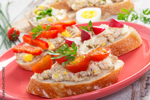 Crusty sandwiches or baguette with mackerel or tuna fish paste on plate, healthy nutrition