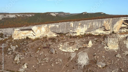 Pan over mountain with ancient cave monastery in its hills. Qaçi Kalyon cave monastery, Crimea. photo