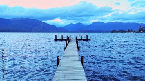 wooden pier on big lake in Te Anau, New Zealand.