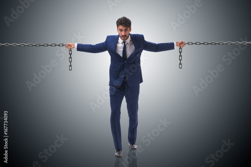 Businessman holding chains in business concept
