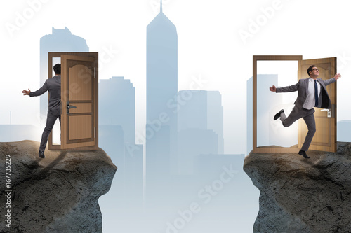 Businessman in teleportation concept with doors photo