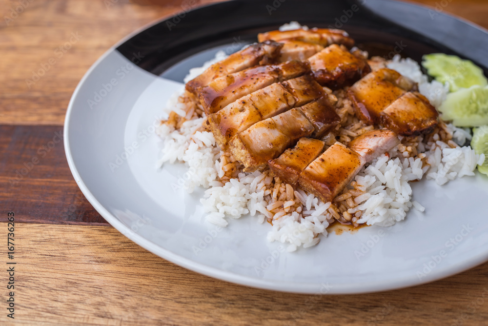 Barbecued red pork in sauce with rice and cucumber Barbecued red pork in sauce with rice and cucumber