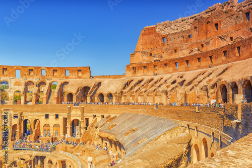  Tourist's Inside the amphitheater of Coliseum in Rome- one of wonders of the world  in the morning time.