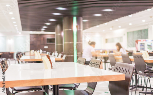 Modern interior of cafeteria or canteen with chairs and tables photo