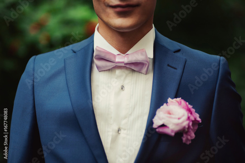 Groom portrait on a park at a wedding day