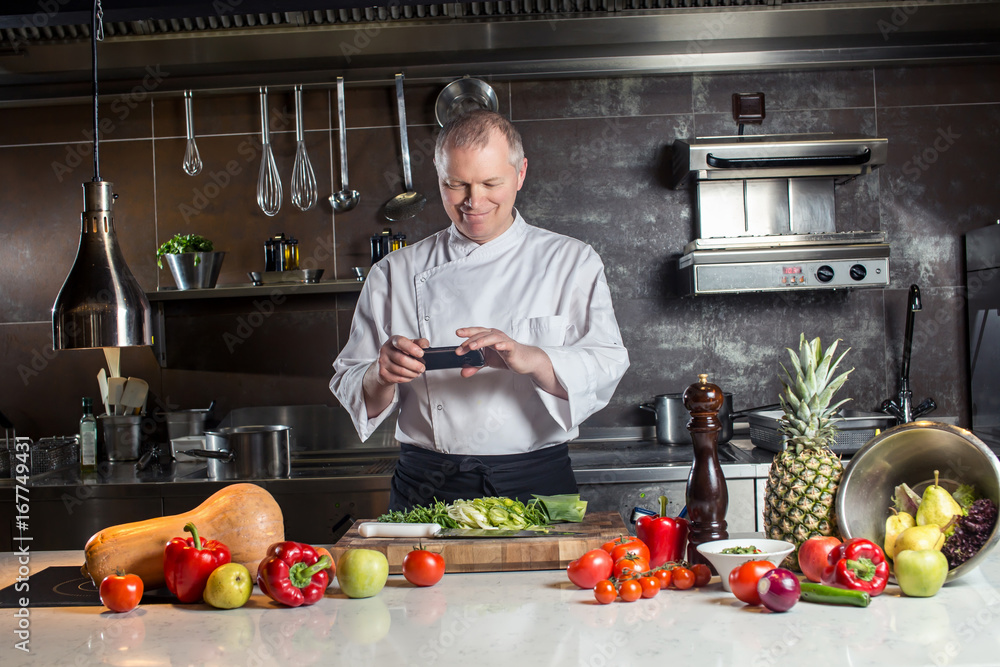 chef shooting with his cell phone camera his cooked food chef shooting with his cell phone camera his cooked food