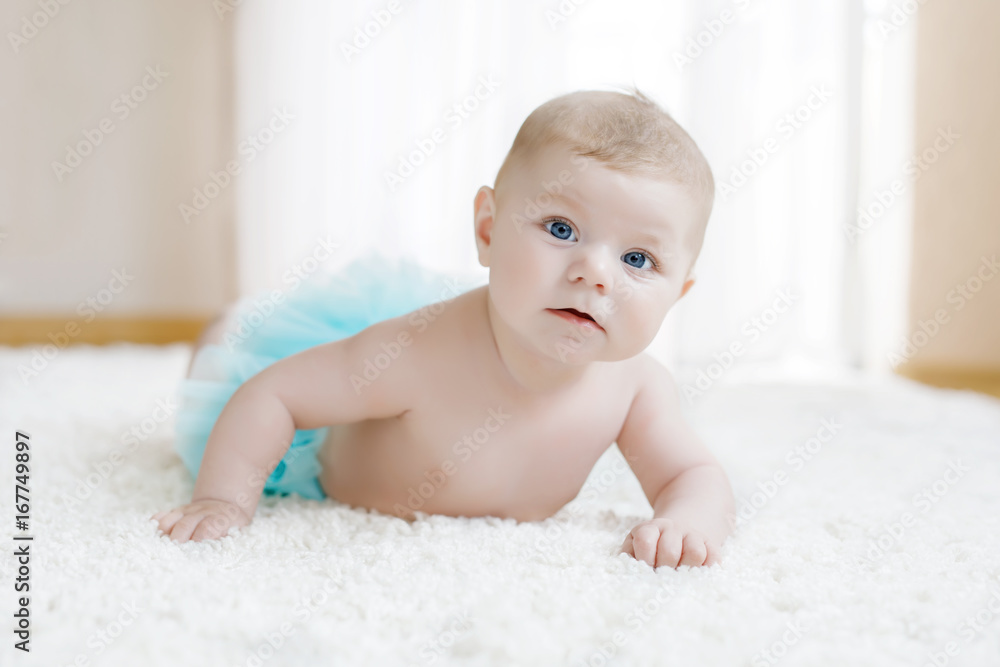 Adorable baby girl on white background wearing turquoise tutu skirt. Adorable baby girl on white background wearing turquoise tutu skirt.