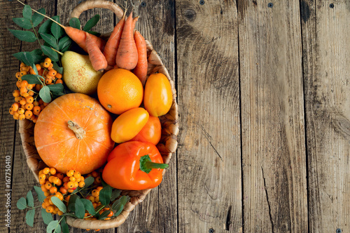 Autumn vegetables and fruits on wooden background