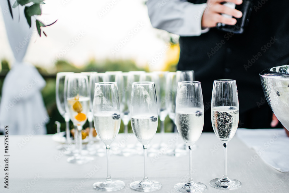 waiter and glasses of champagne on table waiter and glasses of champagne on table