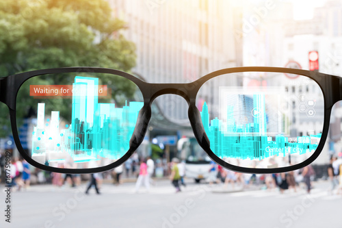 Augmented reality , smart AR glasses technology , smart city , internet of things concept. Customer using AR application see digital 3d rendering building with blur city background.