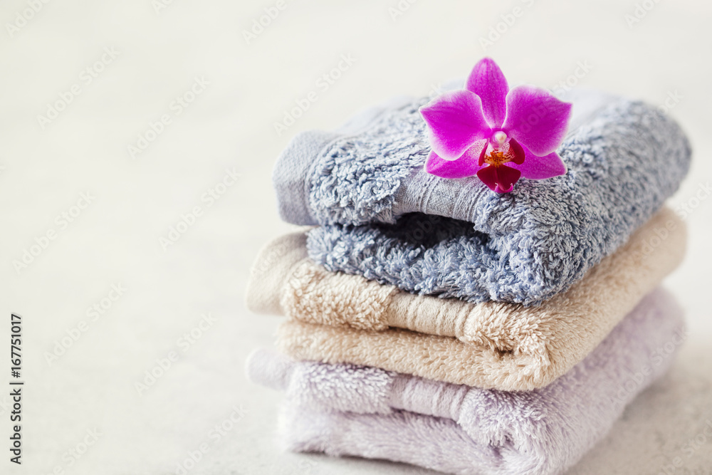 Bath towel set on wooden background with orchid Bath towel set on wooden background with orchid