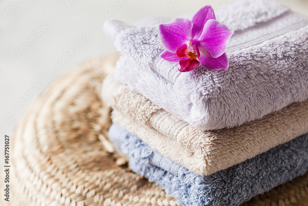 Bath towel set on wooden background with orchid Bath towel set on wooden background with orchid