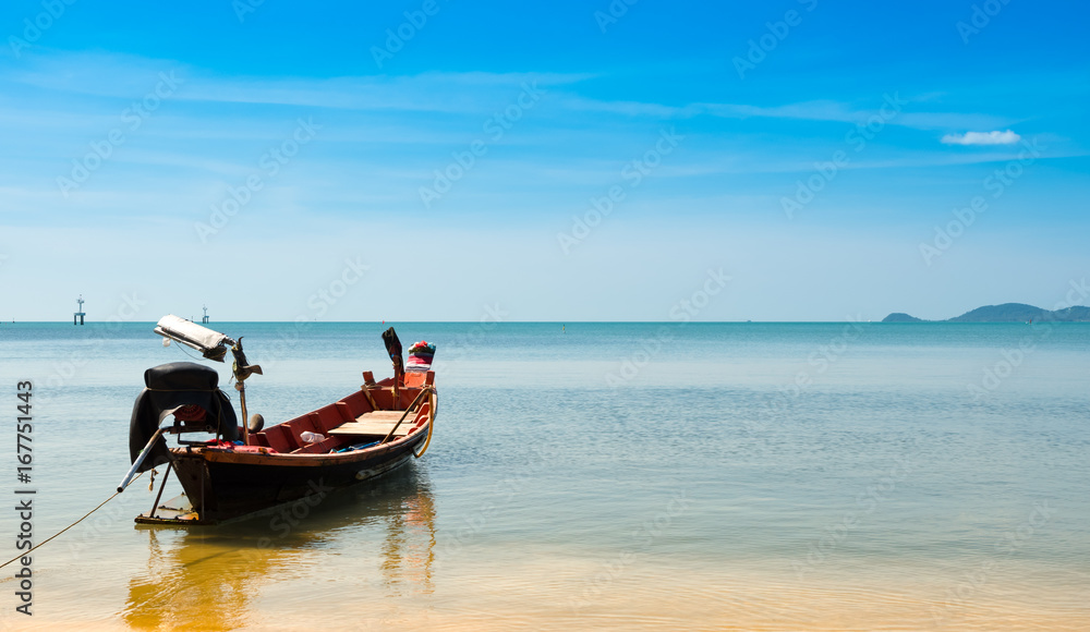 wooden fising boat on blue sky and sea beach wiht copy space.