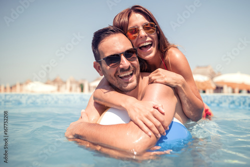 Couple having fun in swimming pool © ivanko80