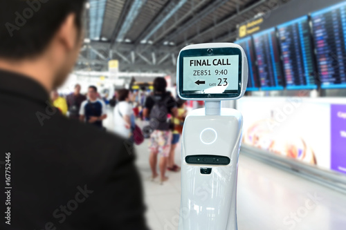 Wallpaper Mural Businessman suit passenger use self driving chcek-in robots assistant for ticket and accompany them to their gate at international airport. Torontodigital.ca