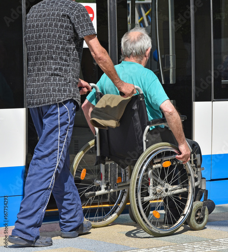 Man in wheelchair waits for the tram photo