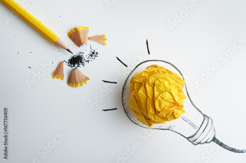the yellow pencil with yellow crumpled paper ball and hand drawn a light bulb , creative innovation idea symbol concept