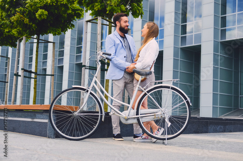 Fototapeta Naklejka Na Ścianę i Meble -  A couple on a date after bicycle ride in a city.