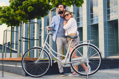 Fototapeta Naklejka Na Ścianę i Meble -  A couple on a date after bicycle ride in a city.