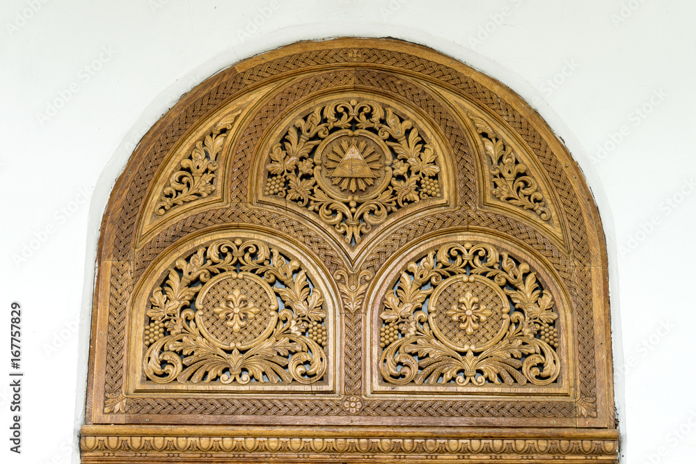 Carved wooden decorations on white wall