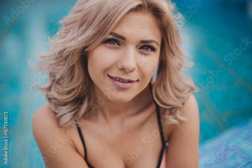 Girl in bathing suit swimming pool blue color