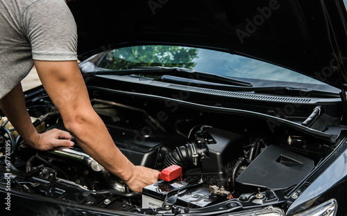 Hand of mechanic is repairing car engine © magneticmcc