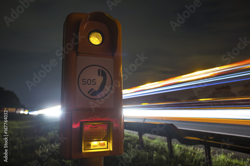 highway sos column at night photo