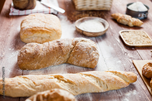 Freshly baked delicious bread on a rustic wooden table, healthy eating concept