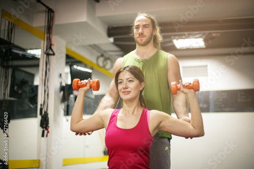 Personal trainer training his client in the gym. Shot of a personal trainer training his client in the gym.