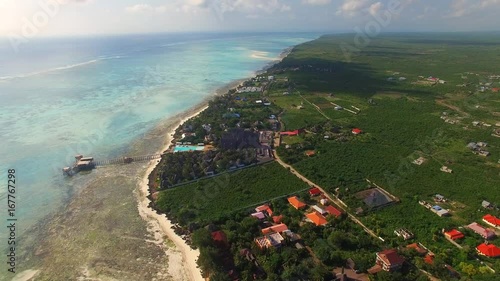 Aerial view of Nungwi village discrict, Blue Lagoon, North part of Zanzibar, White beach, Palm paradise, Tanzania from above photo